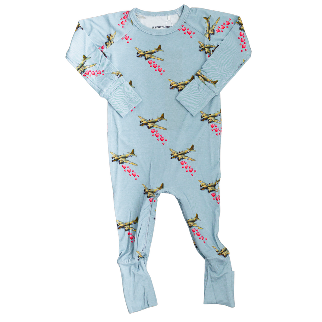 Light blue baby onesie with airplane pattern on a white background