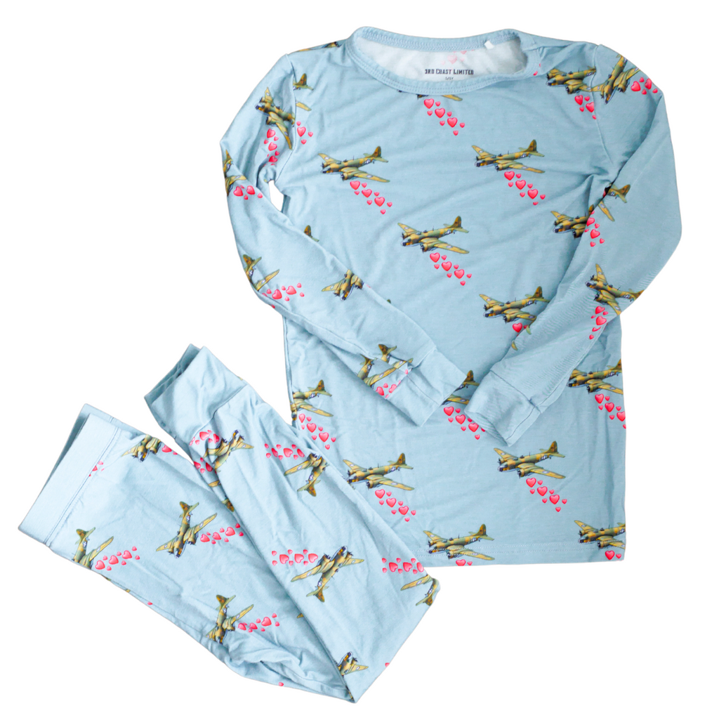 Children's pajama set with airplane pattern on a light blue background
