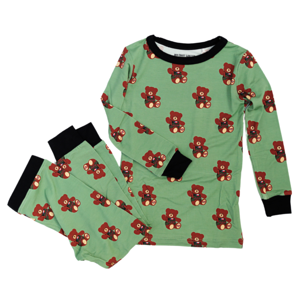 Children's pajama set with teddy bear pattern on a green background