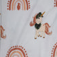 Close-up of cream baby romper fabric featuring a rust-colored rainbow with a grenade silhouette in the center and a tactical unicorn with a helmet and scarf, designed by 3rd Coast Limited.